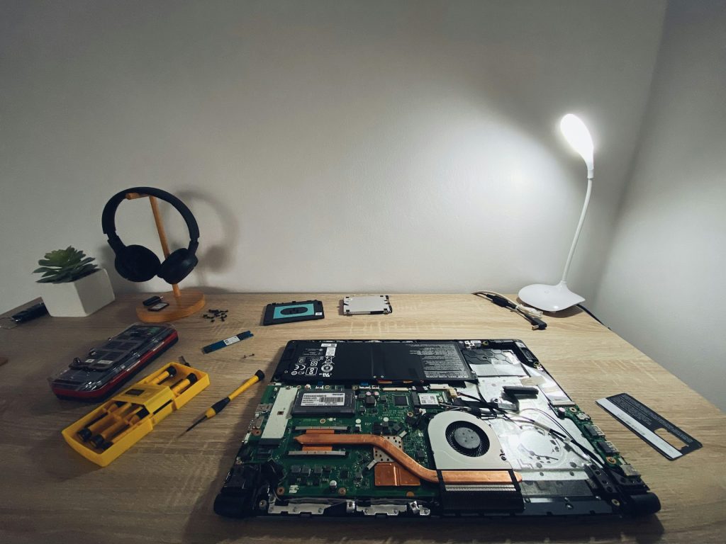 a table with a laptop and headphones on it