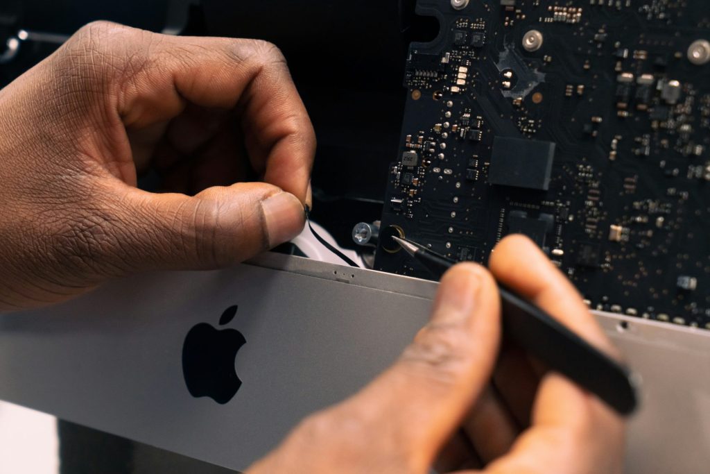 a man repairing apple computer
