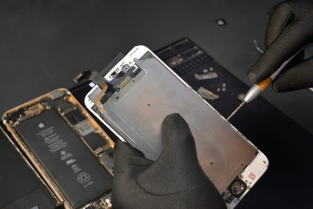 person fixing iphone screen